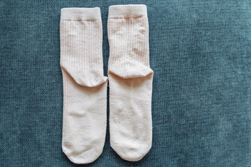 two old worn socks, one cleaned of pilling, the other not