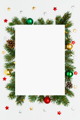 Christmas, New Year vertical frame of fir tree branches, Christmas baubles, decorations on white flat lay background. Perfect for holiday greetings, banners, social media. Copy space.