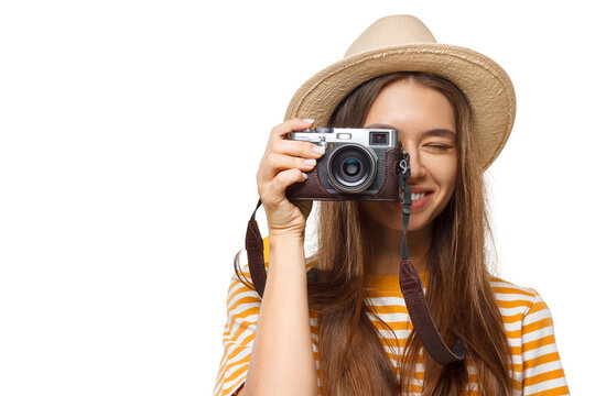 Close-up portrait of happy smiling young female photographer, tourist holding photo camera