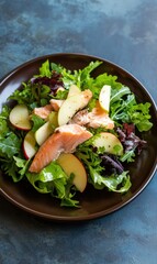 Salmon Salad With Sliced Apples And Mixed Greens Presented On a Brown Plate