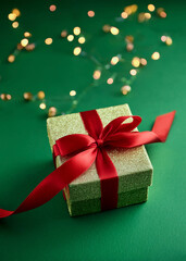 christmas gift boxes with red bow on green background. Christmas or new year 's greeting card.