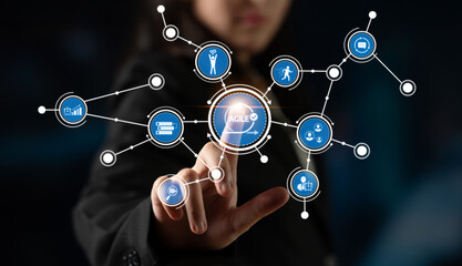 A business professional engages with a digital agile network interface, showcasing interactive icons representing various concepts in a modern technology setting. Crux