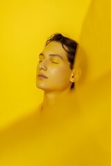 Portrait in yellow light. Person illuminated by strong yellow light, warm glow, artistic portrait emphasizing smooth skin, soft shadows, monochromatic warm-toned atmosphere.