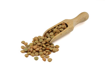 Green lentils in wooden scoop on isolated white background. Top view, copy space. Flat lay. (real photo. NOT artificial intelligence generated.)