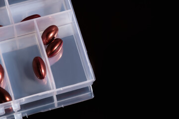 red pills in pill organizer