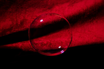 Transparent bubble on red velvet cloth