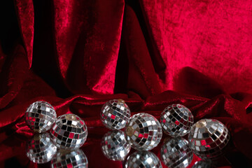 Disco balls on red velvet cloth