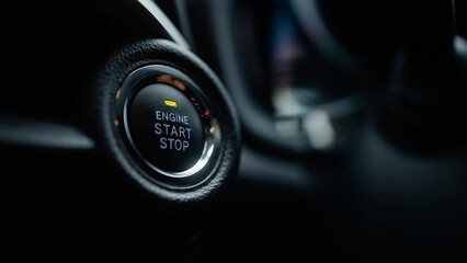 Close-up view of a modern vehicle's engine start stop button, showcasing sleek design and technology, emphasizing the innovation in automotive engineering and user experience