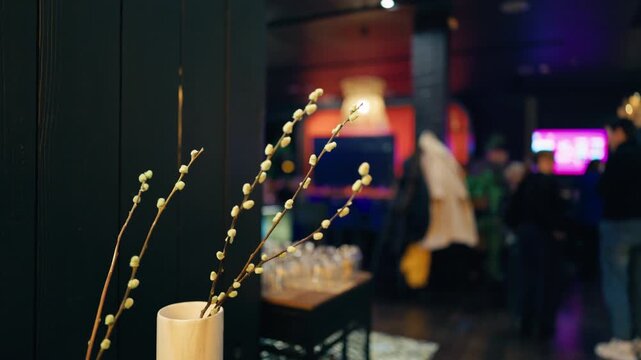 Elegant lounge ambiance, Vase holds willow branches as neon and soft lights craft cozy atmosphere