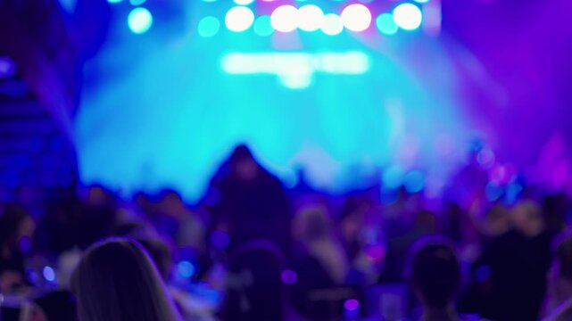 Vivid concert atmosphere, Hazy figures and scattered glows produce electrifying music event ambiance