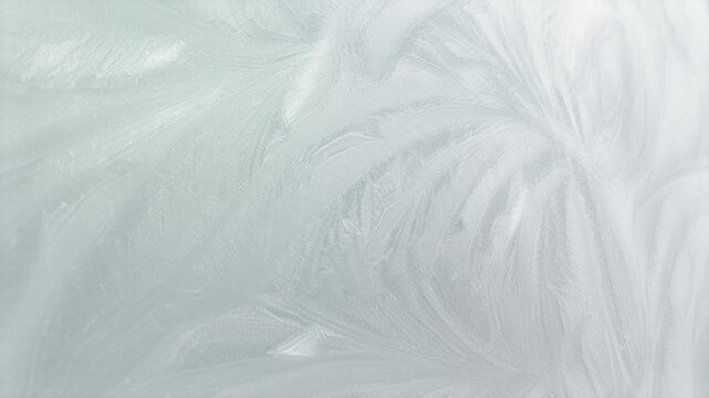 Rotating ice themed winter motion background with patterns of swirling icy frost particles naturally forming cold chilly frost pretty floral organic shapes in cold chilly cool icy white 4K animated