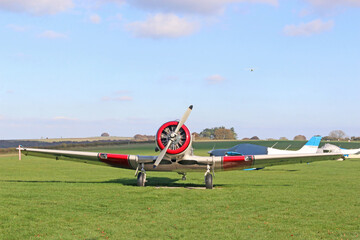 Light airplane standing on a grass runway