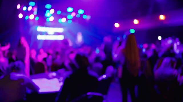 Casual networking under purple lights, Informal professional meetup with vibrant stage lighting