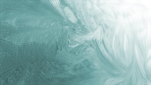 Rotating ice themed winter background of defocused soft swirling icy frost particle patterns naturally forming cold chilly frost pretty floral organic shapes in cold chilly cool icy white 4K animated