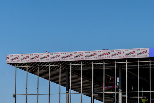 Chandler, AZ - Dec. 1, 2025: Building under construction using Owens Corning Titanium PSU30, a high-temp self-adhered underlayment,  for waterproofing protection of the roof.