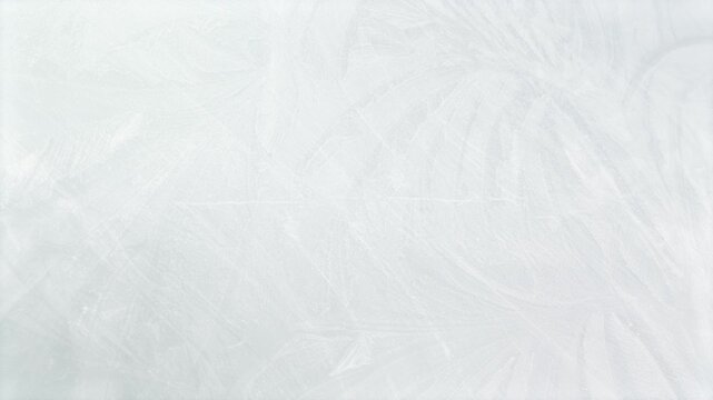 Rotating ice themed winter motion background with patterns of swirling icy frost particles naturally forming cold chilly frost pretty floral organic shapes in cold chilly cool icy white 4K animated