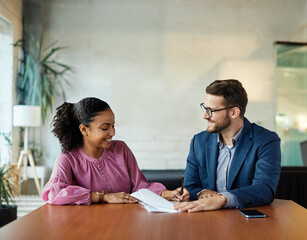 Group of young and senior business people having a meeting and signing a contract agreement in the office. Teamwork and success concept