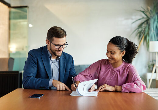 Group of young and senior business people having a meeting and signing a contract agreement in the office. Teamwork and success concept