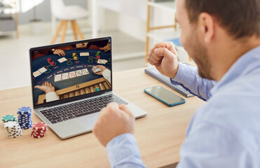 Online happy casino winner at computer laptop male gambler playing, wager on casino games through Internet, prolific online gambling, virtual poker website or platform for money, amusement, blackjack