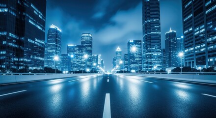 A breathtaking view of a modern cityscape at night, with tall skyscrapers and bright lights reflecting on the wet road. The scene exudes a sense of energy and progress in an urban environment.