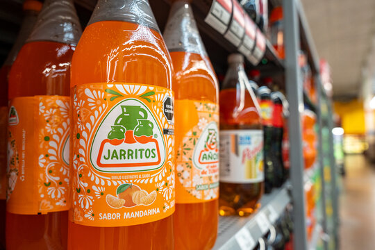 Mandarin flavored Jarritos soda glass bottles displayed at Walmart. Novamex, Foque brand, originated in Mexico City, Mexico (since 1950). Jalisco, Mexico, December 4, 2025. refresco.