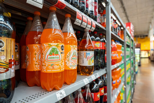 Mandarin flavored Jarritos soda glass bottles displayed at Walmart. Novamex, Foque brand, originated in Mexico City, Mexico (since 1950). Jalisco, Mexico, December 4, 2025. refresco.