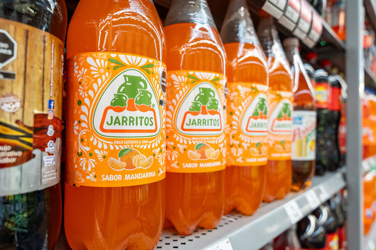Mandarin flavored Jarritos soda glass bottles displayed at Walmart. Novamex, Foque brand, originated in Mexico City, Mexico (since 1950). Jalisco, Mexico, December 4, 2025. refresco.