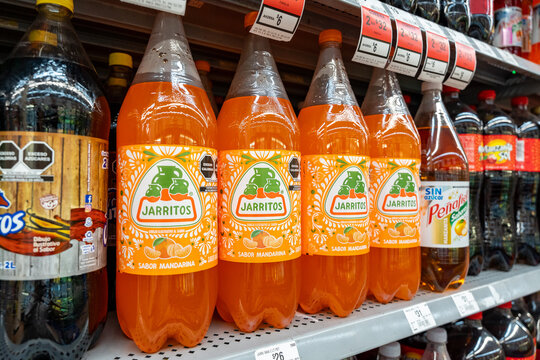 Mandarin flavored Jarritos soda glass bottles displayed at Walmart. Novamex, Foque brand, originated in Mexico City, Mexico (since 1950). Jalisco, Mexico, December 4, 2025. refresco.