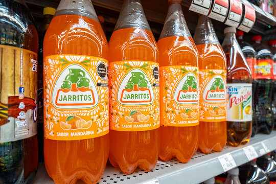 Mandarin flavored Jarritos soda glass bottles displayed at Walmart. Novamex, Foque brand, originated in Mexico City, Mexico (since 1950). Jalisco, Mexico, December 4, 2025. refresco.