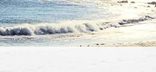 Video of Ocean Roaring in to a Peaceful Conclusion as it Meet the Sandy Shoreline with Space for text, advertisement or message at bottom