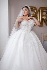 Naklejka premium Bride in a sparkling white gown prepares for her wedding celebration at a beautiful venue