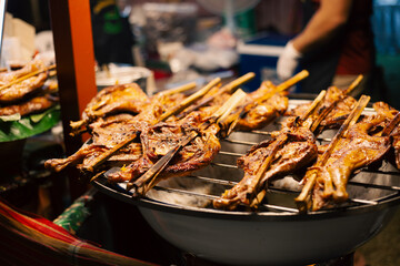 Delicious fresh grilled chicken wings cooking on a barbecue grill for a tasty gourmet meat dinner dish