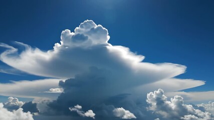 Dramatic cloudscape forming with bright blue sky above, aerial view of cloud development in motion in the atmosphere