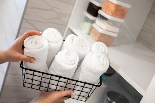 Woman housewife white bathroom general cleaning cupboard shelves storage organizing eco minimalism
