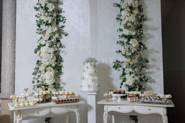 Elegant dessert table decorated with flowers for a special celebration event