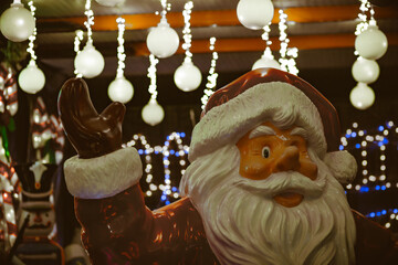 Festive Santa Claus figure surrounded by Christmas lights and decorations – holiday display