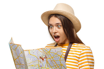 Amazed young woman tourist looking at paper map with mouth open