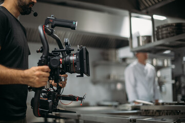 Professional cinema and video camera on the set. Shooting shift, lighting fixtures, shooting equipment and the team. Technique of modern filming and advertising.
