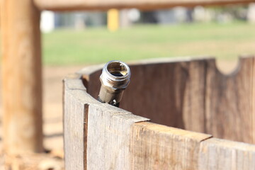 Garden Hose Fitting Attached to Rustic Wooden Barrel