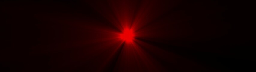 Obraz premium Red starburst light flare emanating from a dark background image