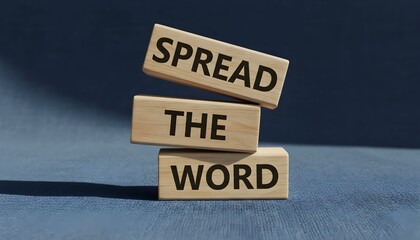 Wooden blocks stacked to form the phrase "SPREAD THE WORD" on a blue background.