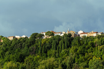 Fototapeta premium Charming hilltop village with lush greenery and historic architecture. Omišalj, Krk island, Croatia