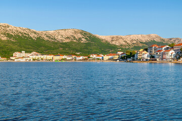 Scenic coastal view of mountains and town by the adriatic sea. Ba&scaron;ka, Krk island, Croatia