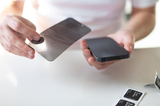 The process of replacing a protective glass on a smartphone - Powered by Adobe