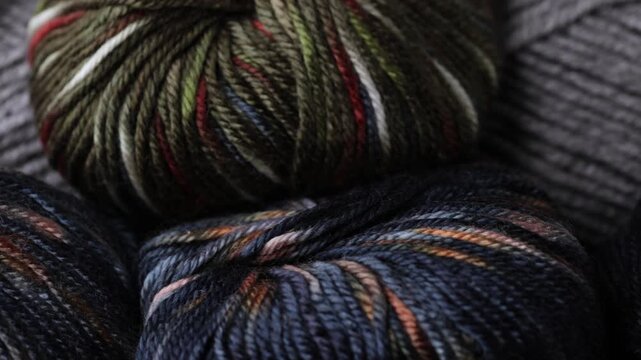 Macro slider shot of assorted yarn skeins with mixed colors and fibers