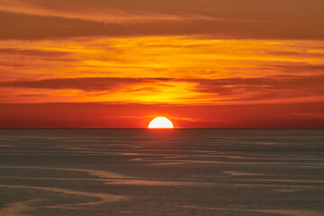 Glowing Sun Setting over Calm Sea