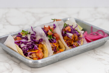 Latino food for a hungry patron includes a trio of beer batter fish tacos