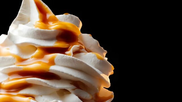Indulgent Creamy Swirl Topped with Rich Caramel Sauce on Black Background.