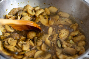 Close-Up of Sautéed Chopped Mushrooms Cooking in a Metal Pan