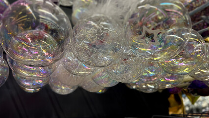 Horizontal mobile photo. Bottom view. Transparent round glass bauble, ball, toy for Christmas tree on mass market, supermarket shelf. Concept of Christmas, New Year eve, gift, sale, shopping